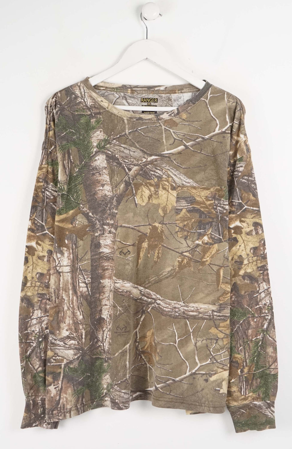 Camouflage-patterned long-sleeve shirt on a white hanger
