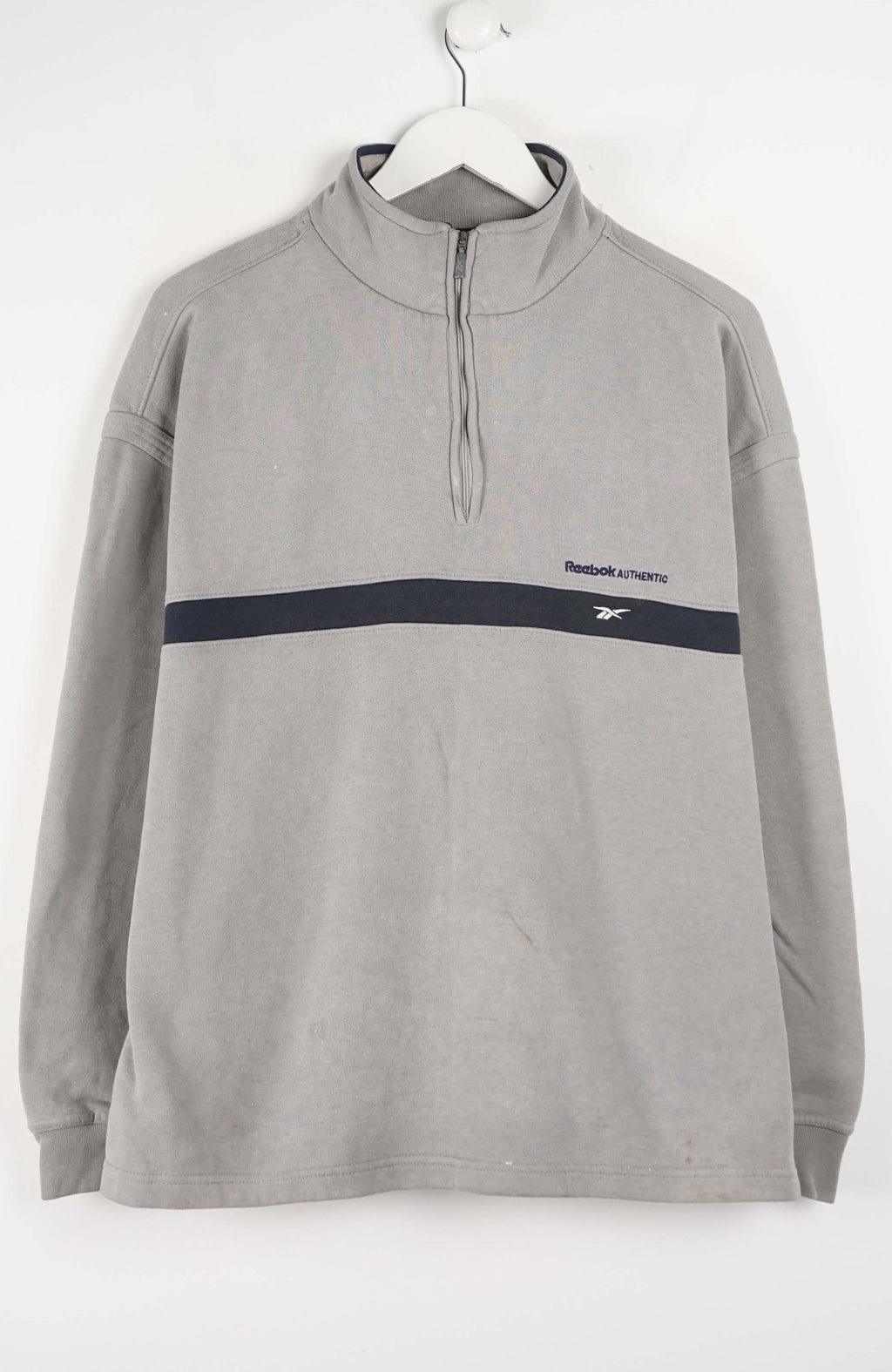 Gray pullover with a black stripe and Reebok logo on a white background