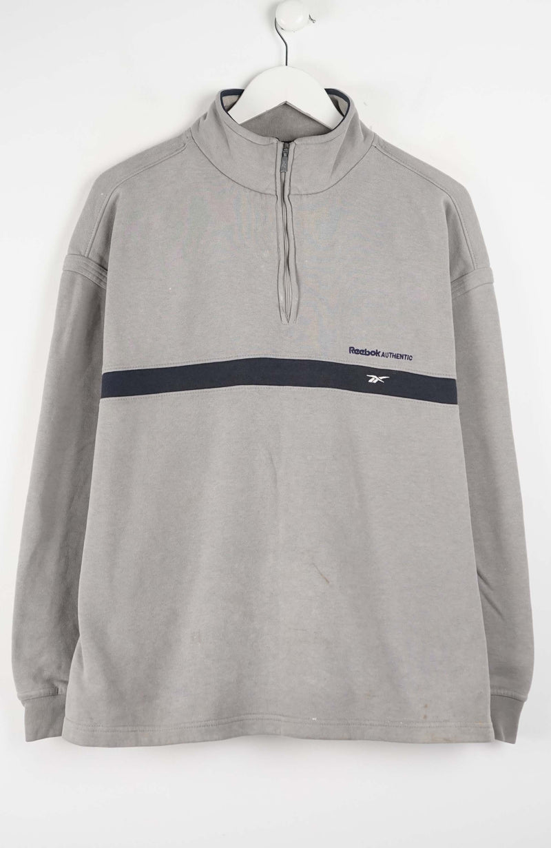 Gray pullover with a black stripe and Reebok logo on a white background