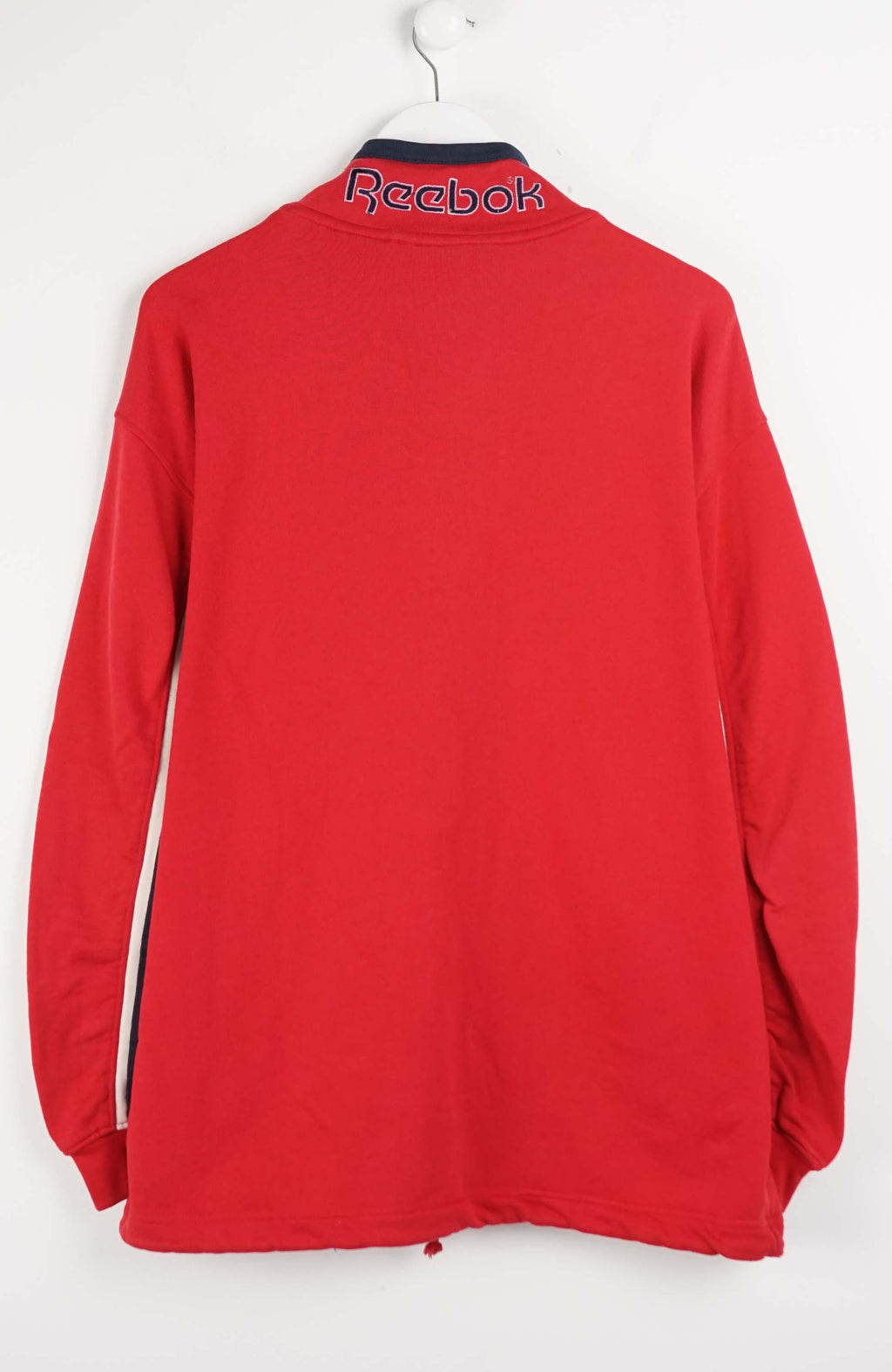 Red long-sleeve shirt with a logo on a white background