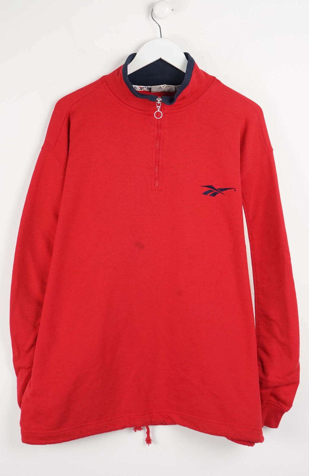 Red long-sleeve shirt with a logo on a white background