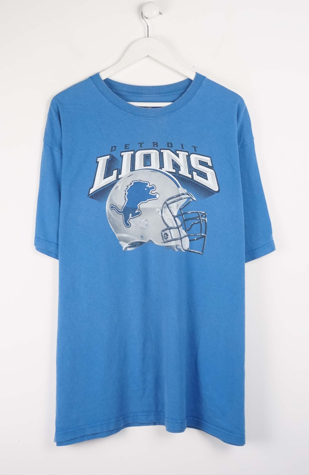 Blue t-shirt with Detroit Lions logo on a white hanger