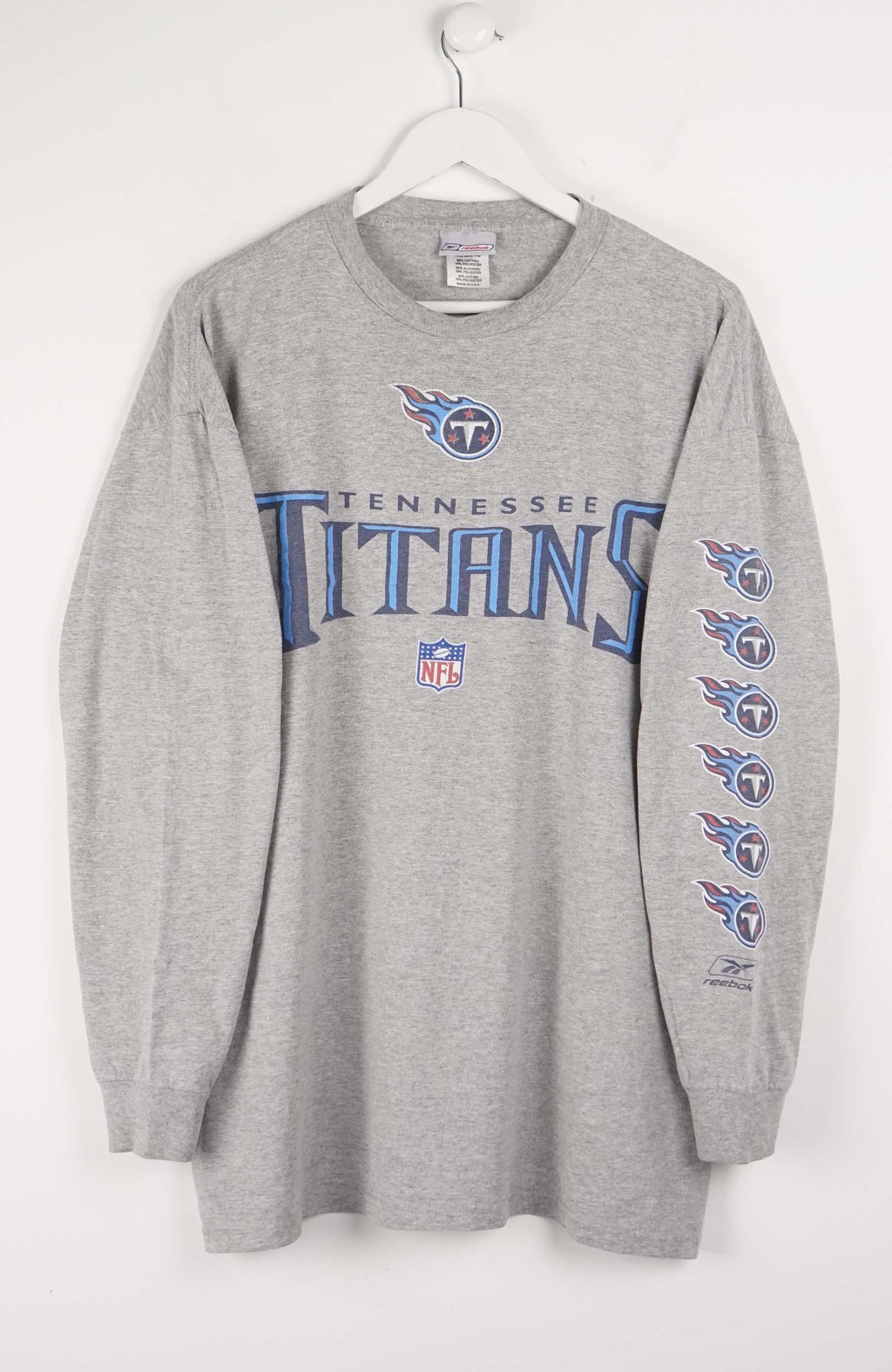 Gray long-sleeve shirt with Tennessee Titans logo on a white background