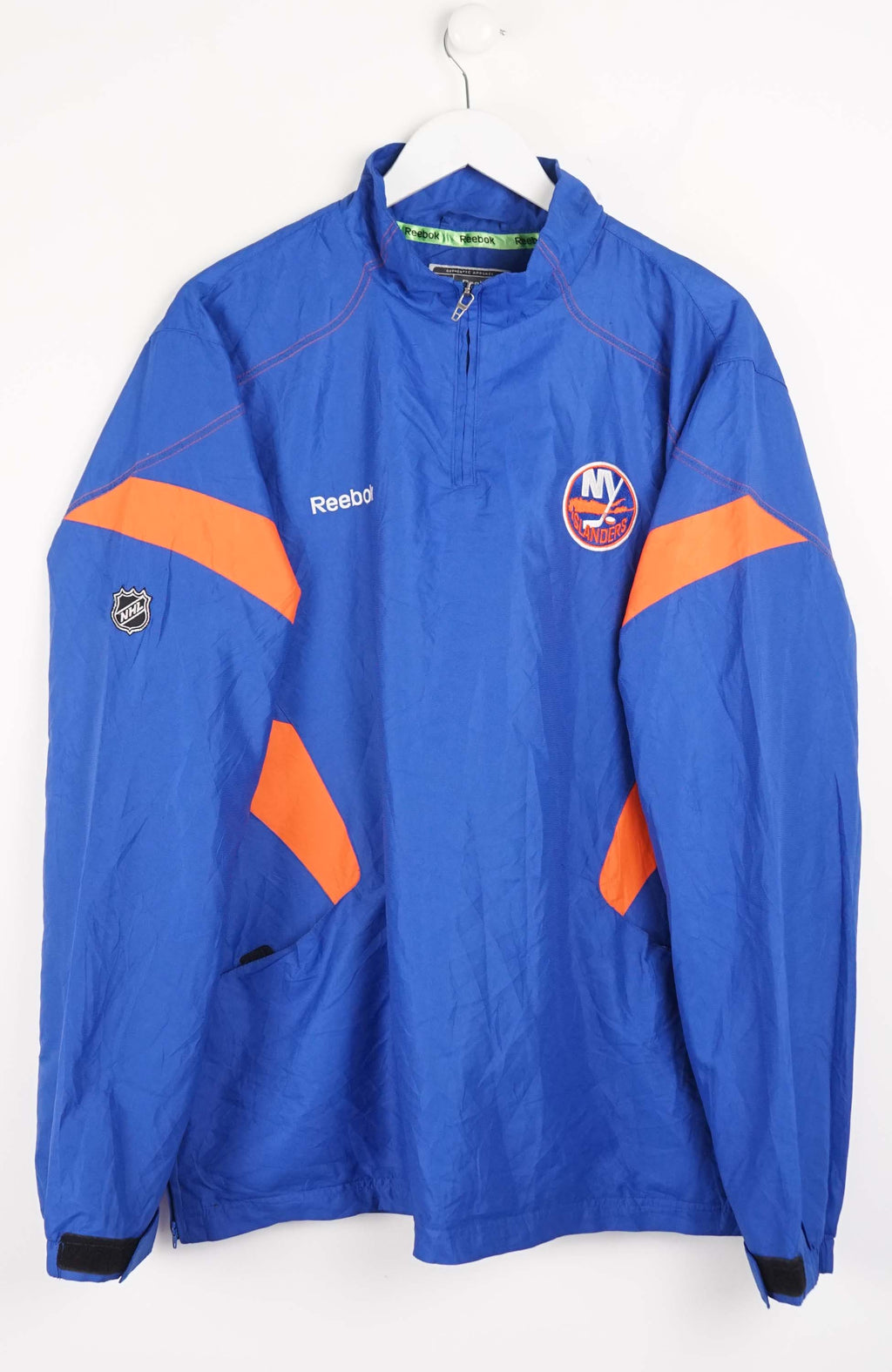 Blue sports jacket with orange accents and Reebok logo on a white background