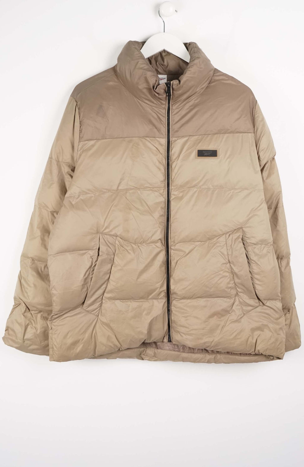 Beige puffer jacket on a white background