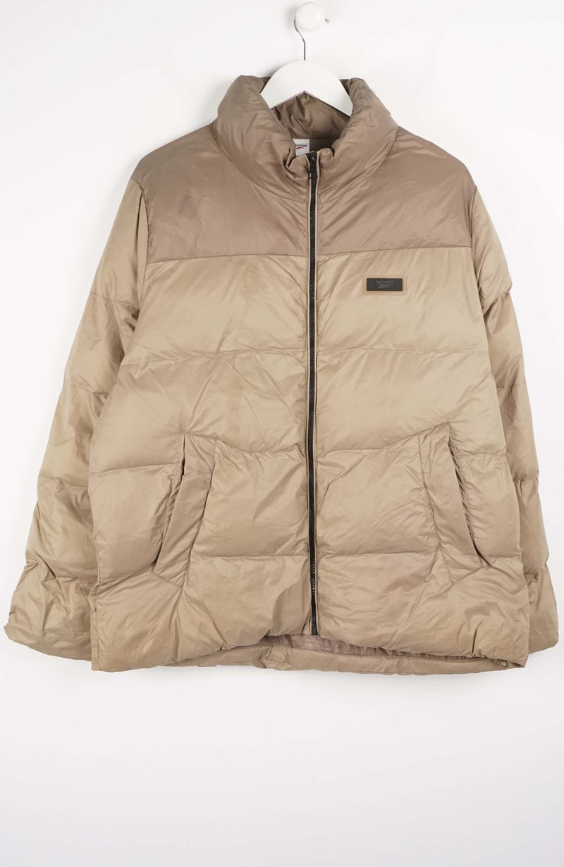 Beige puffer jacket on a white background