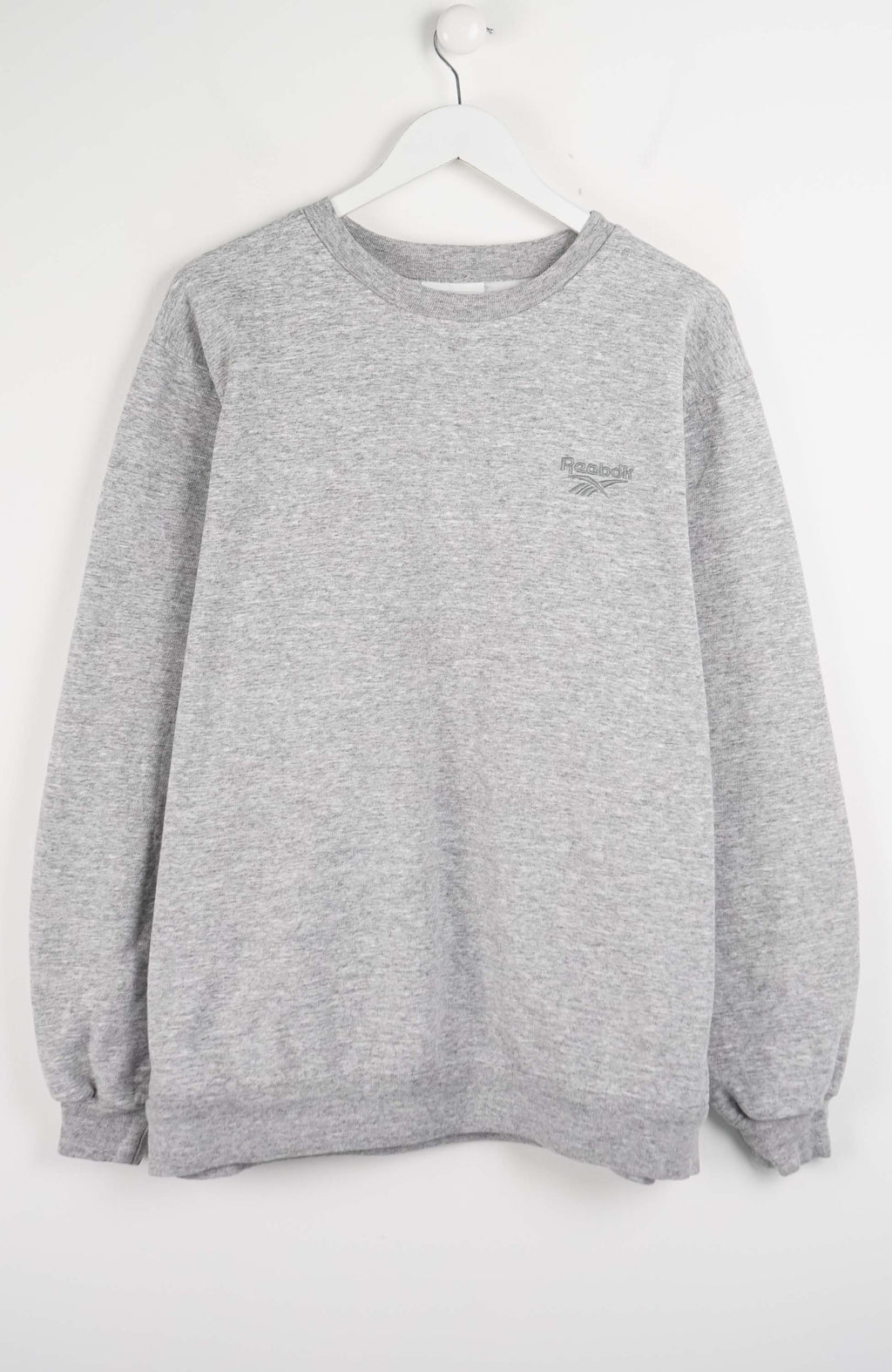 Gray sweatshirt on a hanger against a white background