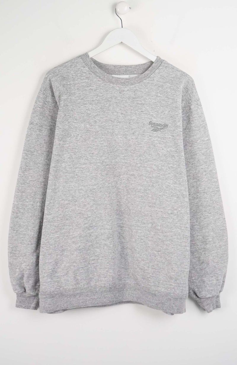 Gray sweatshirt on a hanger against a white background