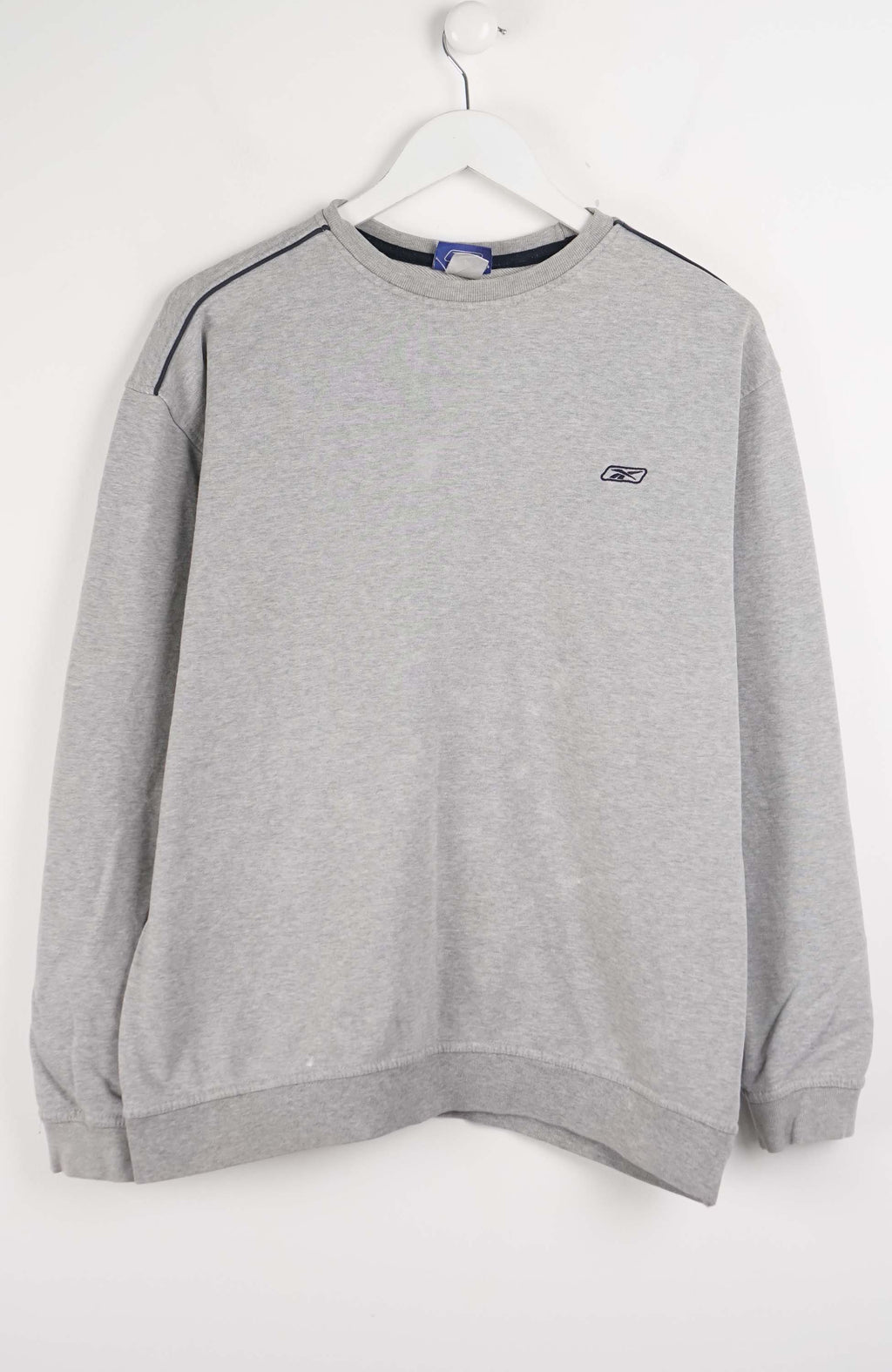 Gray sweatshirt with a brand logo on a white hanger