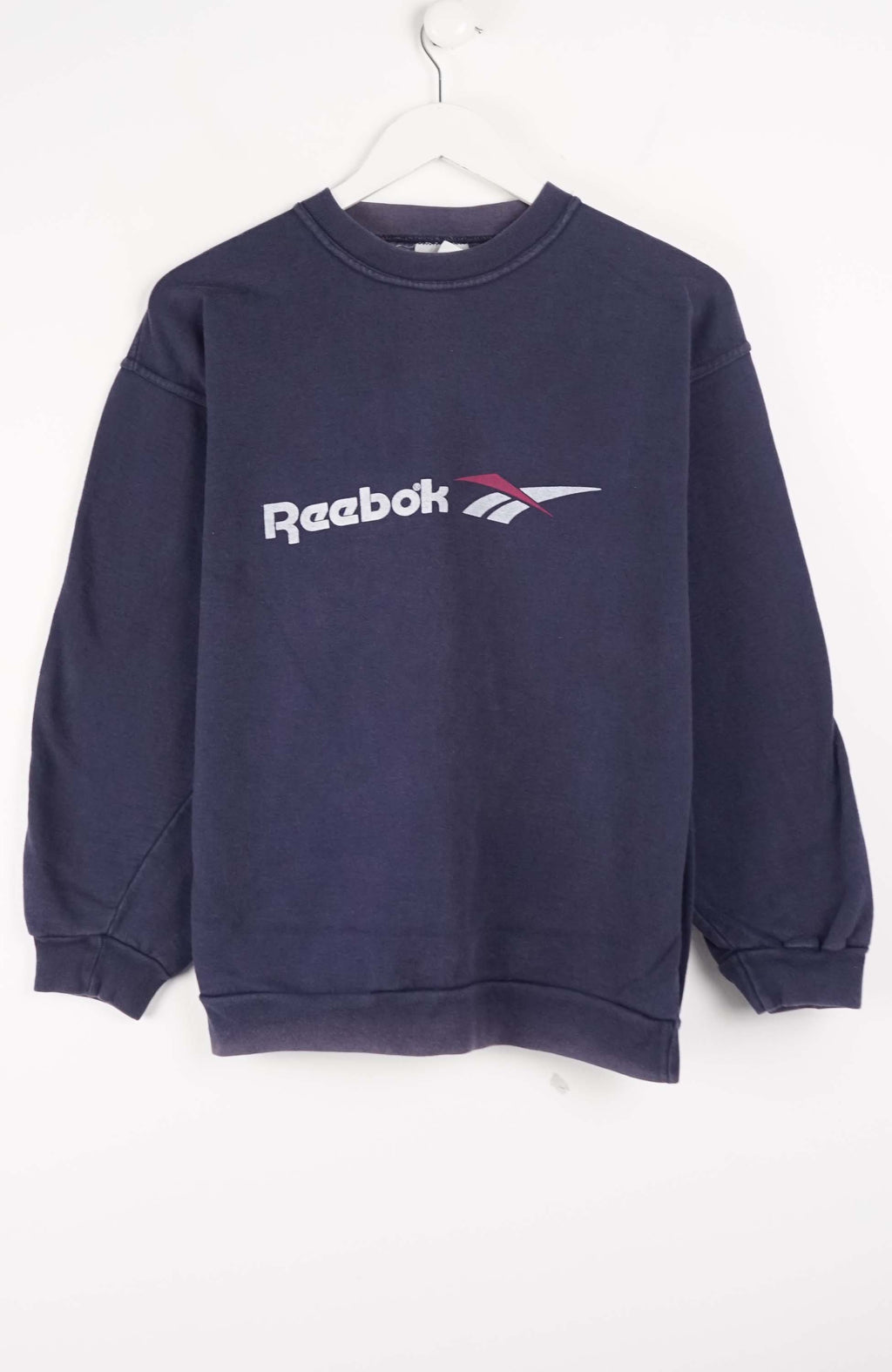 Navy blue Reebok sweatshirt on a white hanger