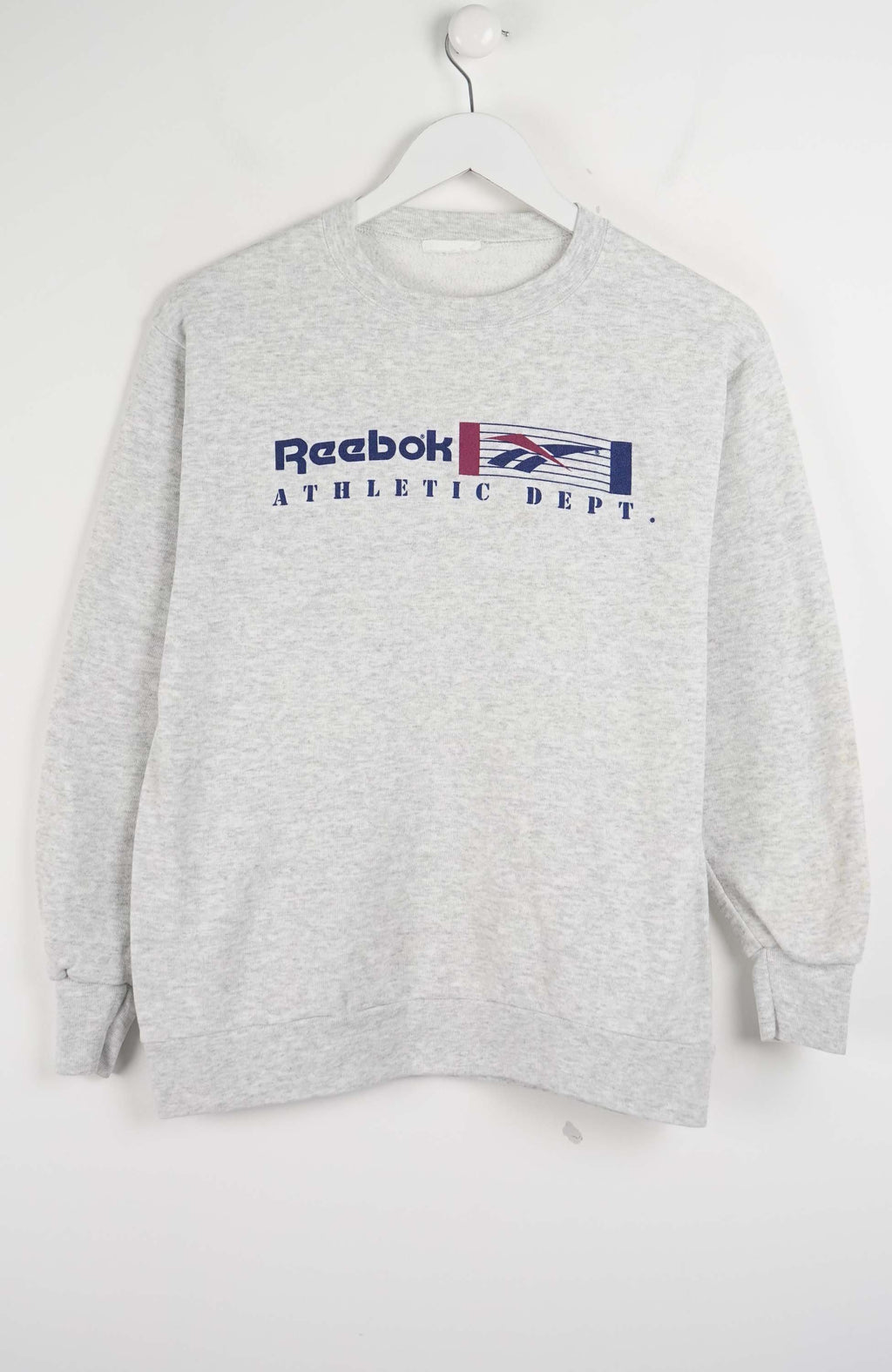 Gray Reebok sweatshirt on a hanger against a white background