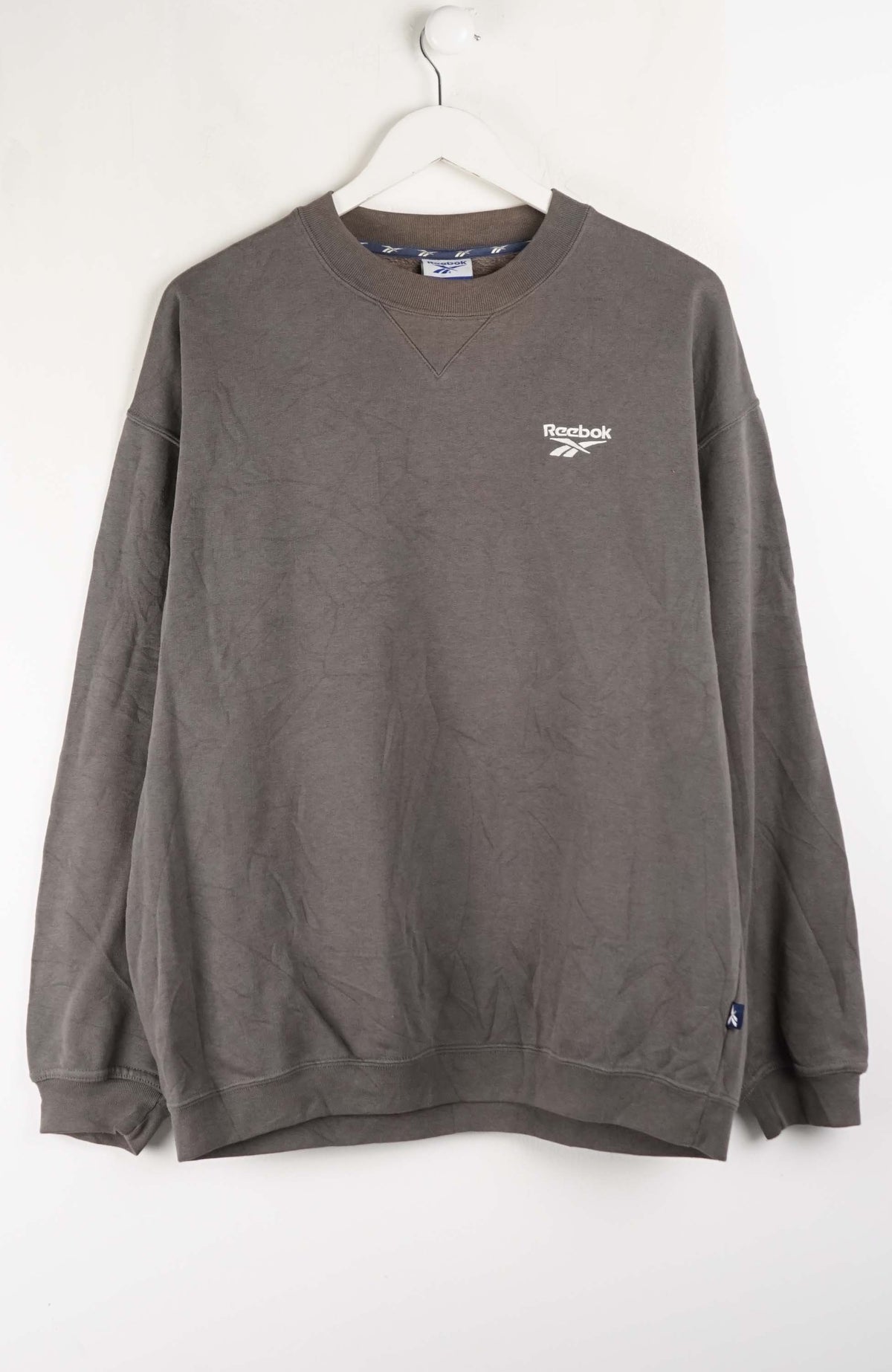 Gray sweatshirt with Reebok logo on a white background
