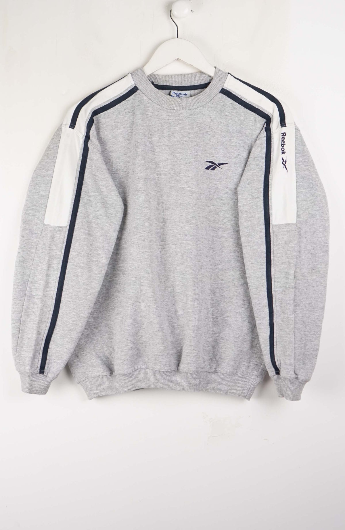 Gray sweatshirt with white and navy stripes on a white background