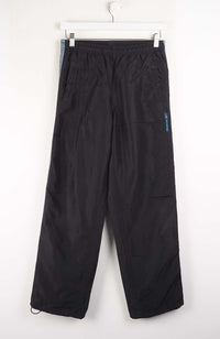 Black pants hanging on a white background