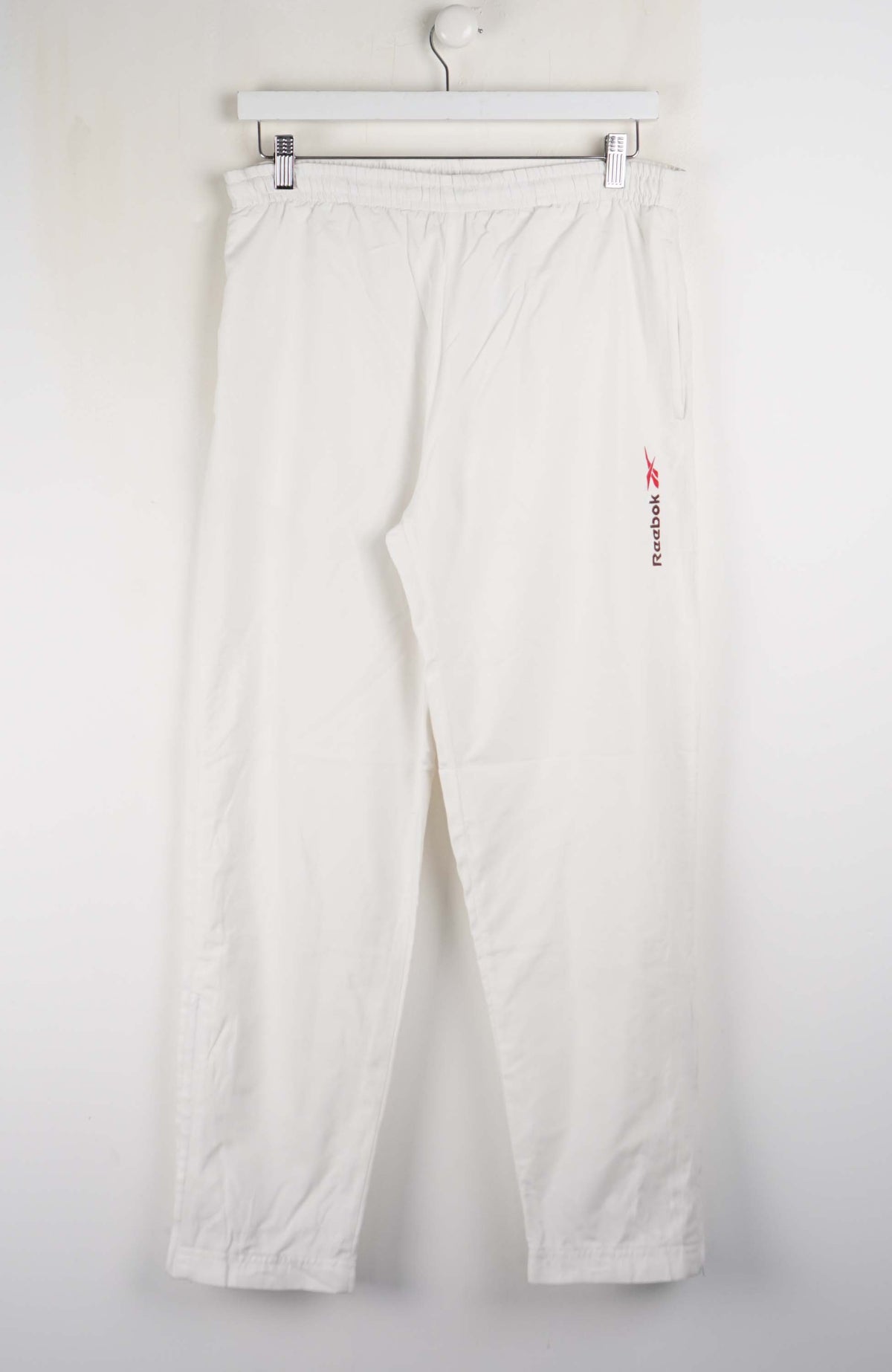 White pants with a red logo on a white background