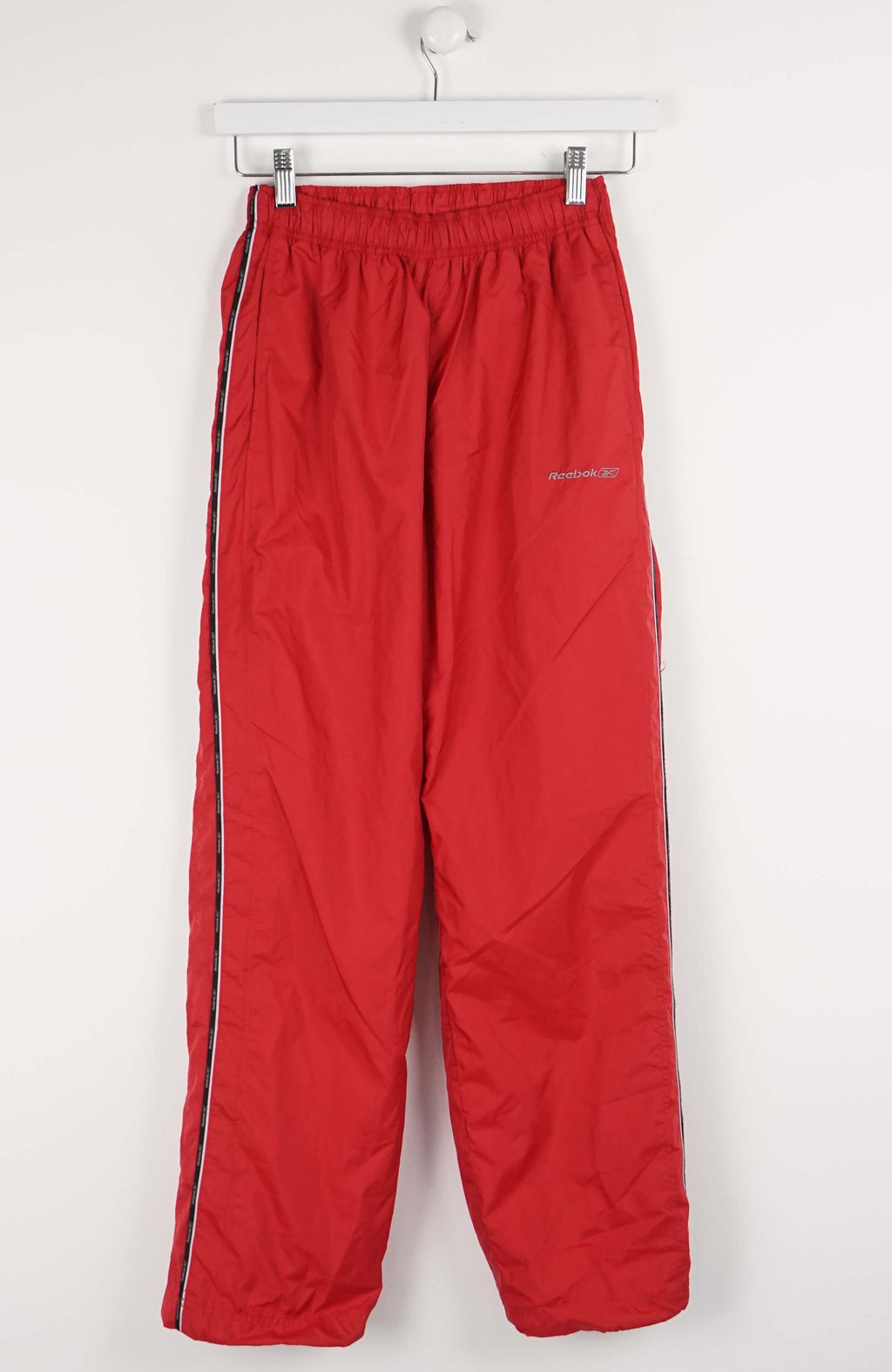 Red pants with a side stripe on a white background