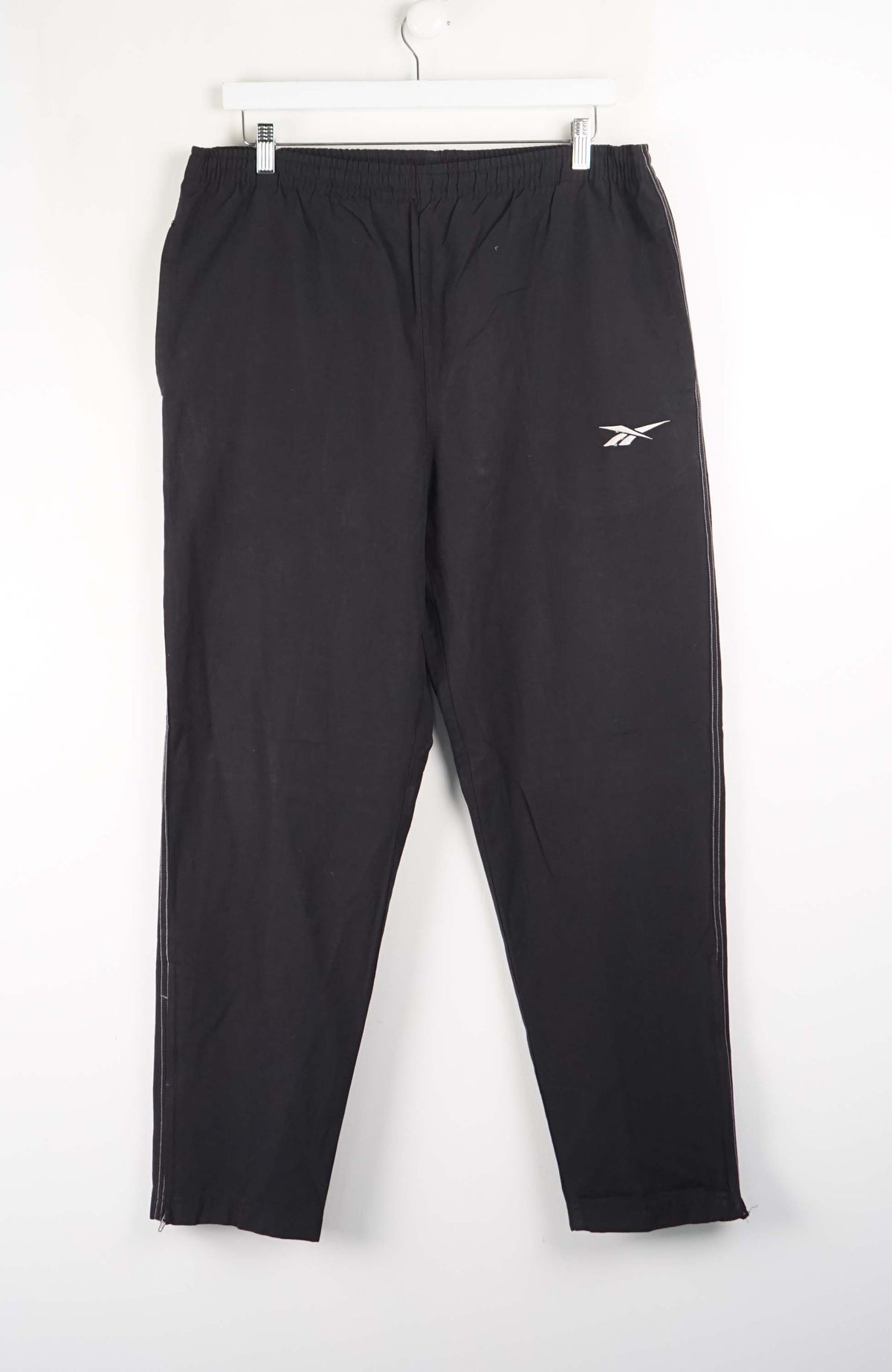 Black sweatpants with a logo on a white background