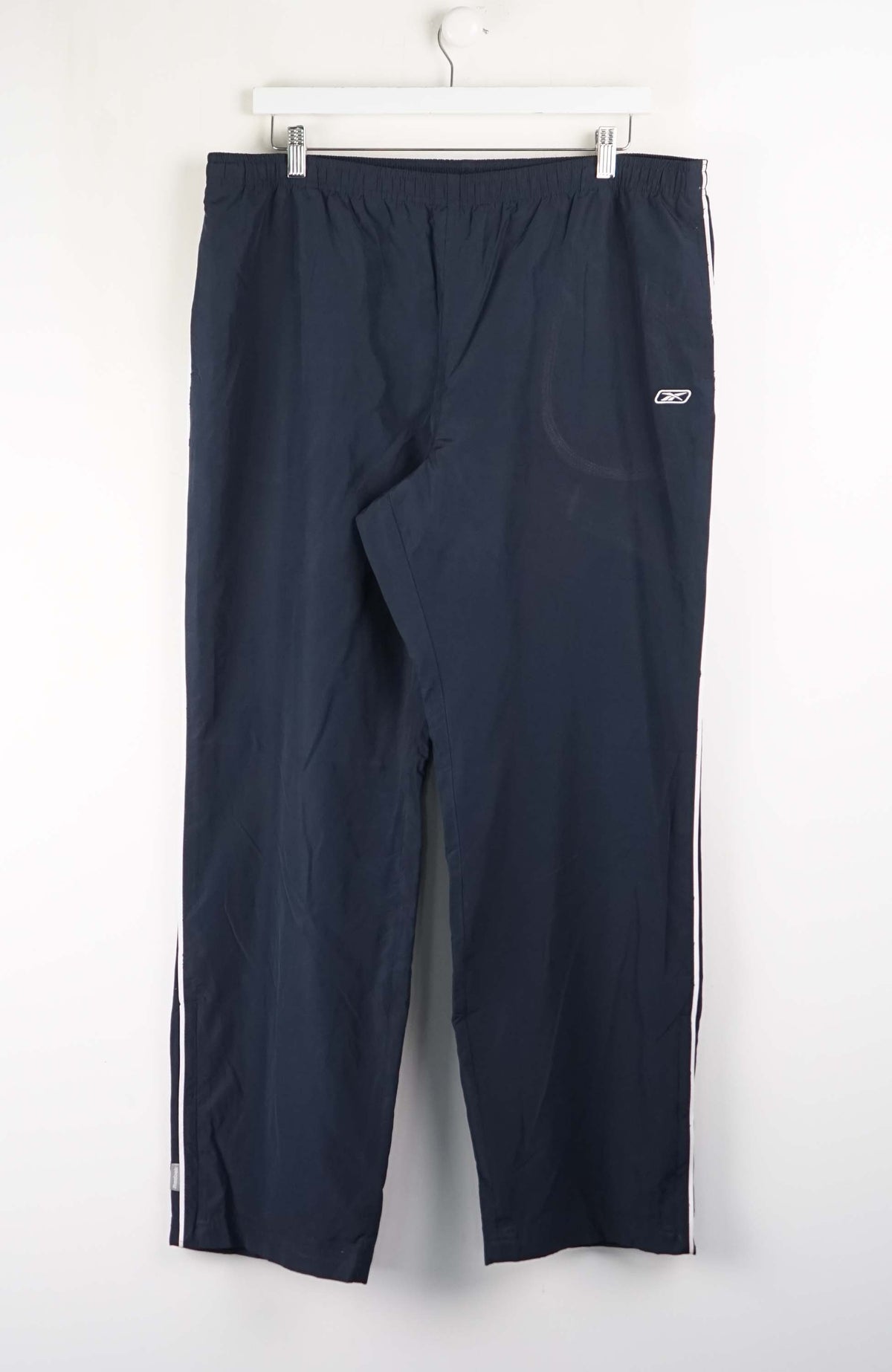 Navy blue pants with white stripes on a white background