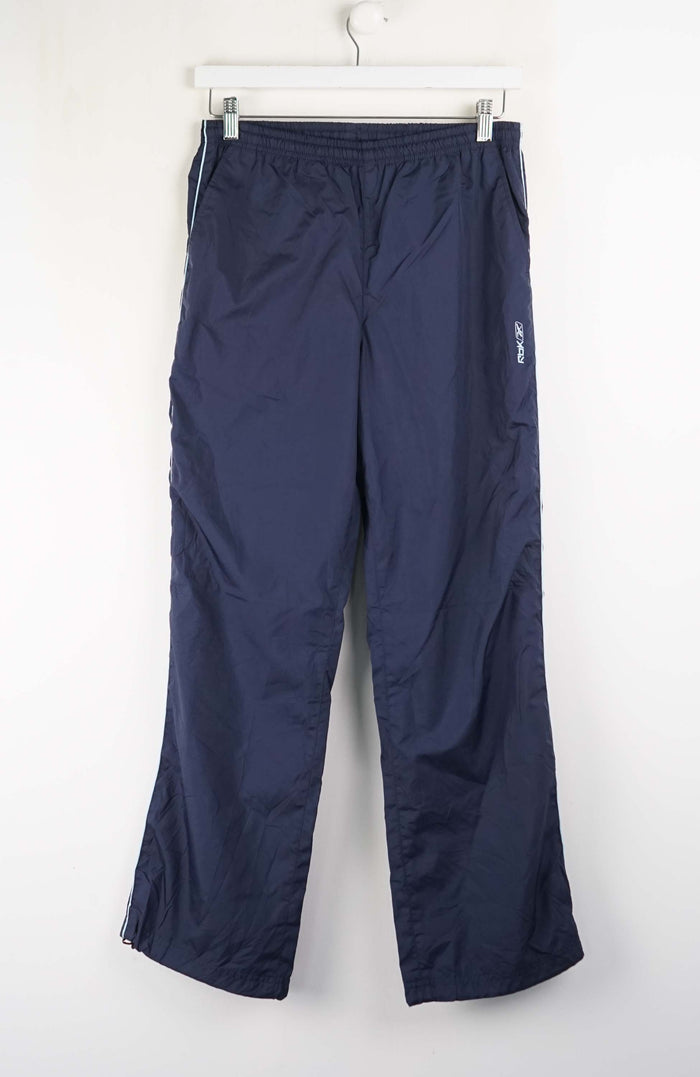 Navy blue pants hanging on a white hanger against a white background