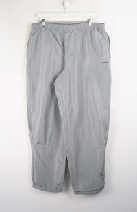 Gray pants hanging on a white background