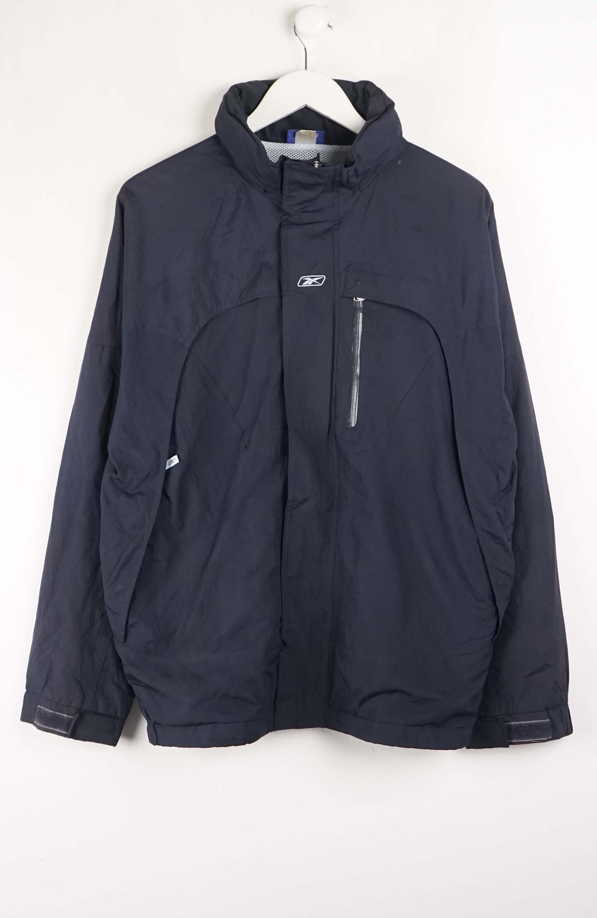 Navy blue jacket on a white hanger against a white background