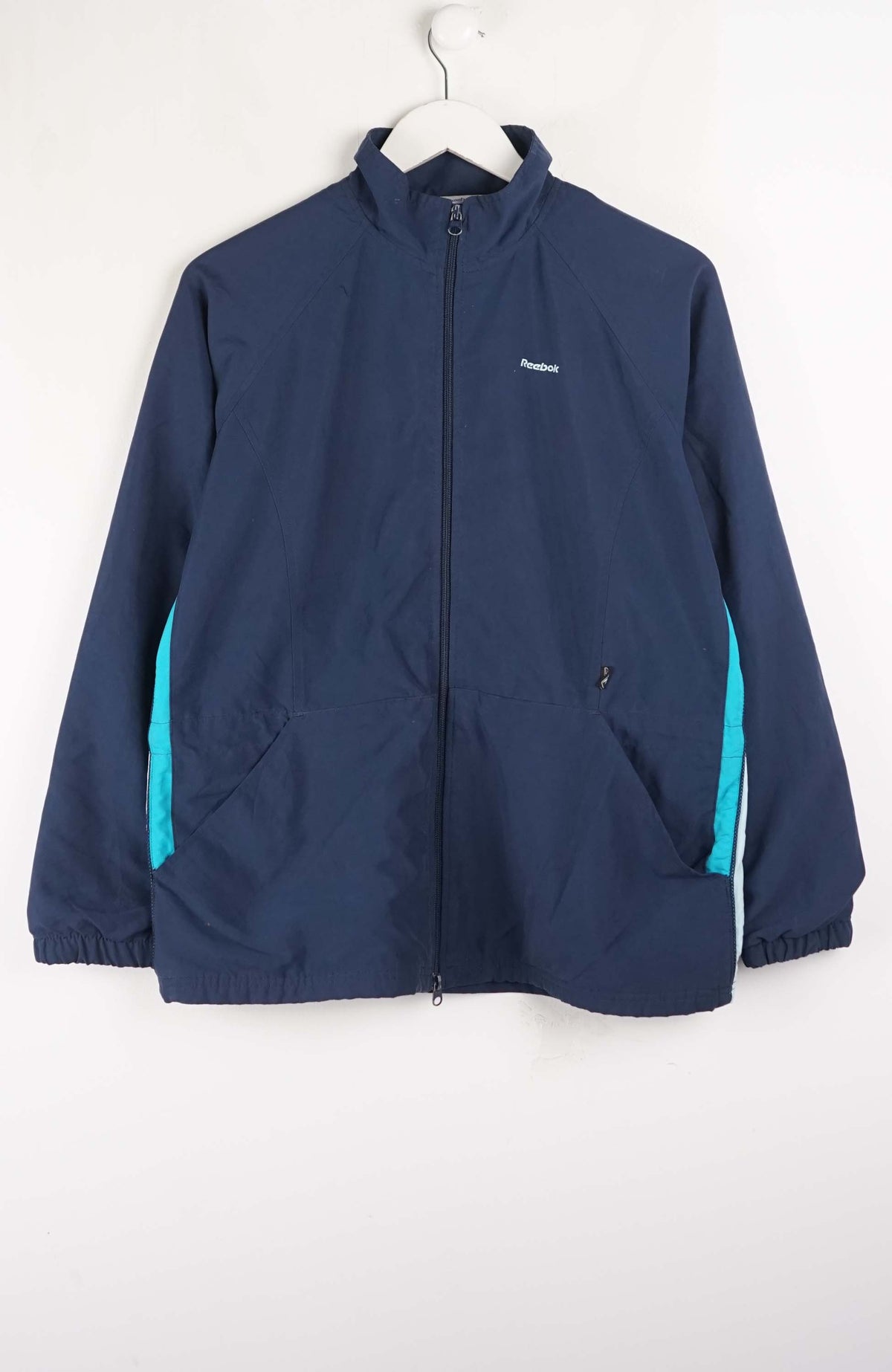 Navy jacket with teal accents on a white background