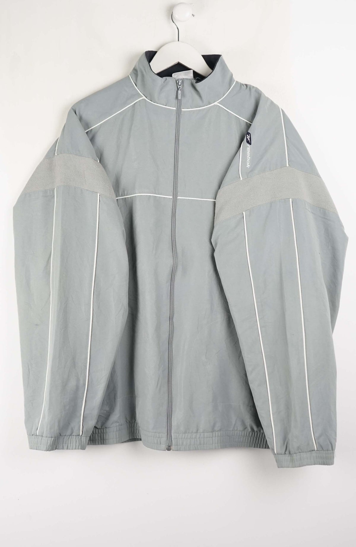 Light gray jacket with white accents on a white background