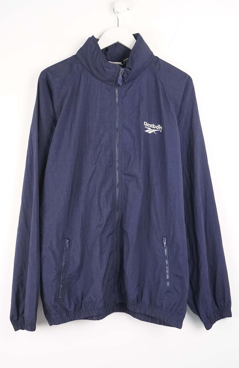 Navy blue jacket with Reebok logo on a white background