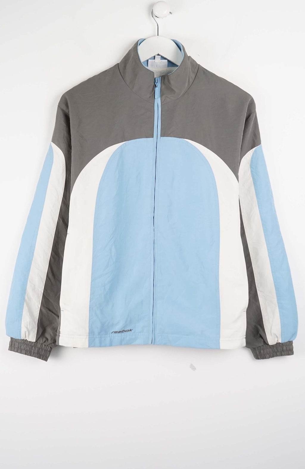 Color-blocked jacket with gray, blue, and white sections on a white background