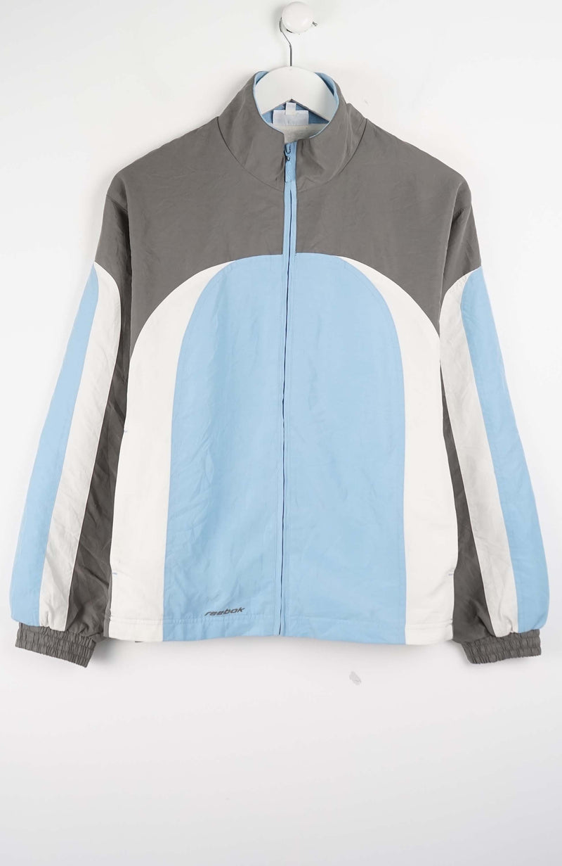 Color-blocked jacket with gray, blue, and white sections on a white background