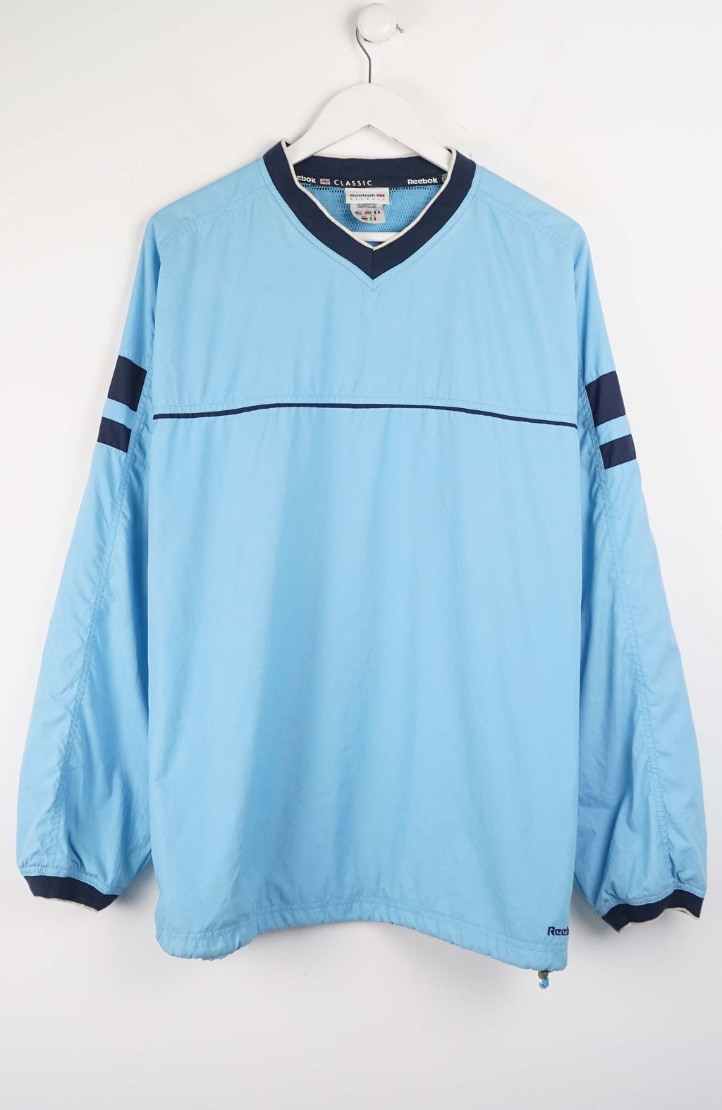 Light blue long-sleeve shirt with dark blue accents on a white background