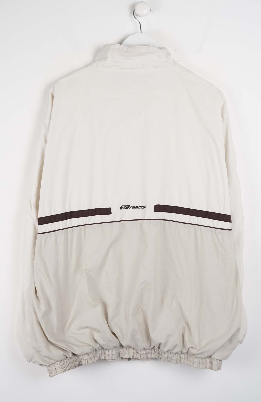 Beige jacket with black accents on a white hanger against a white background