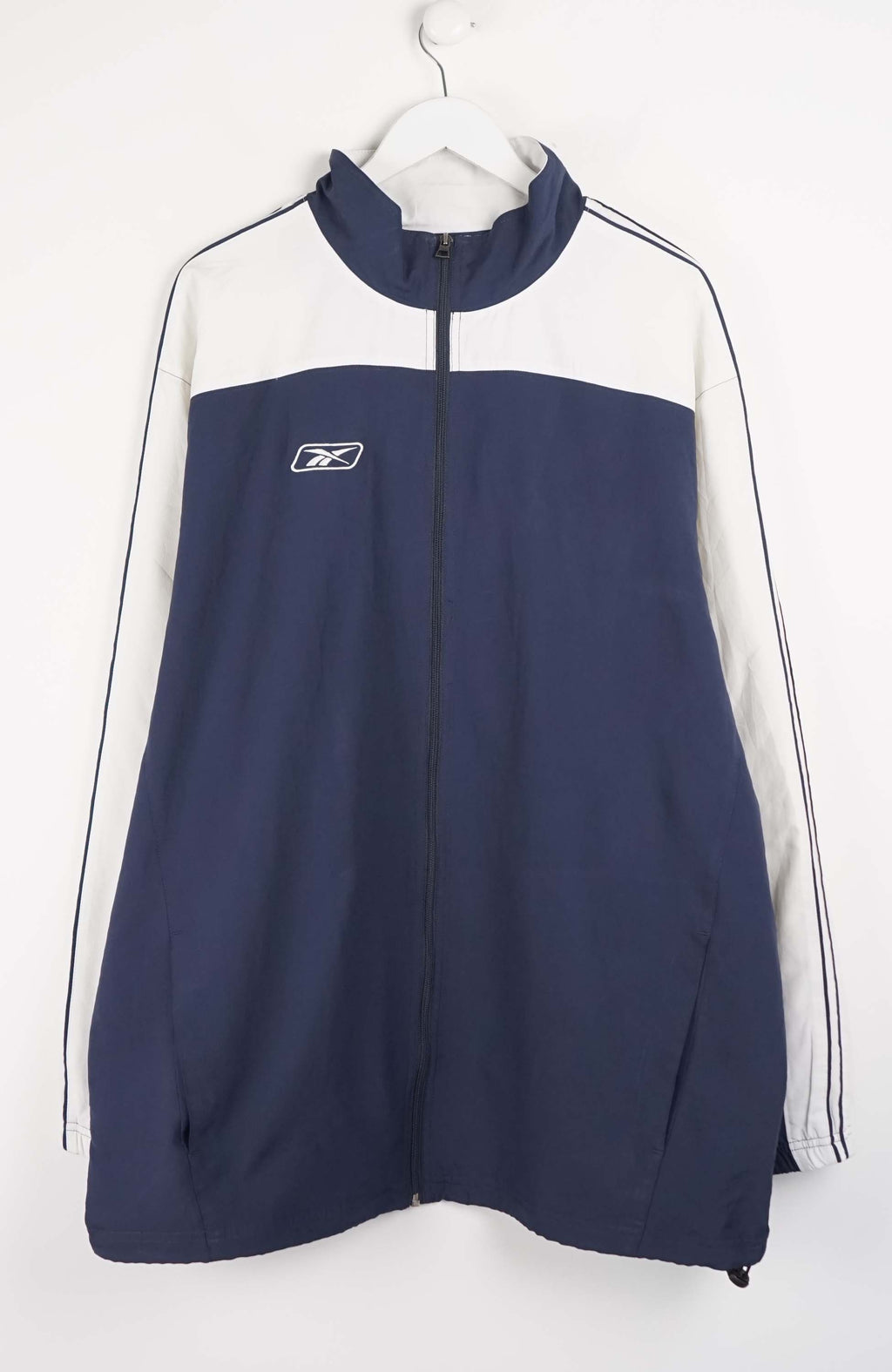 Navy and white tracksuit jacket with a brand logo on a white background