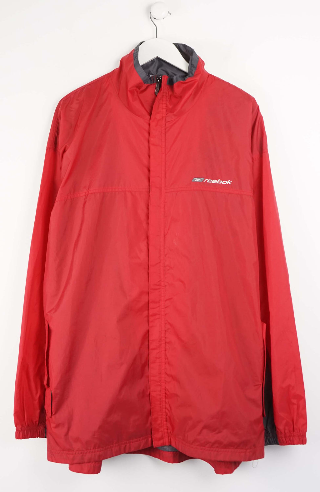Red jacket with Reebok logo on a white background