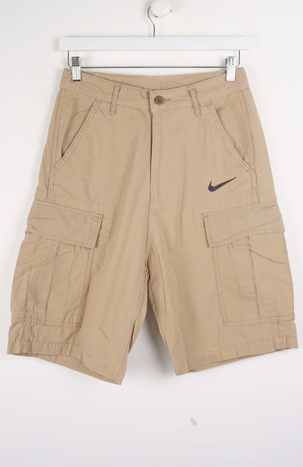 Beige cargo shorts with a Nike logo on a white background
