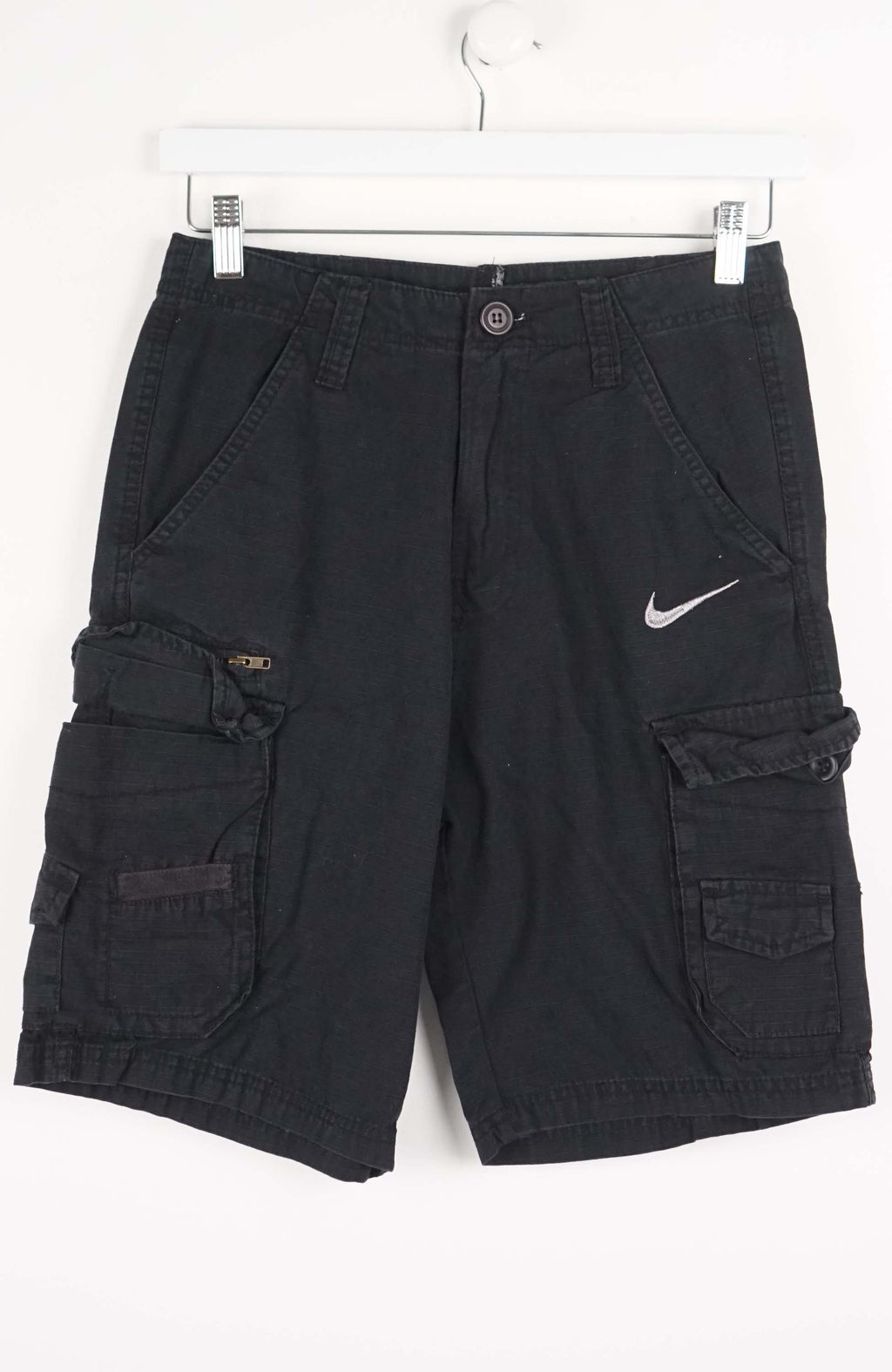 Black cargo shorts with a Nike logo on a white background