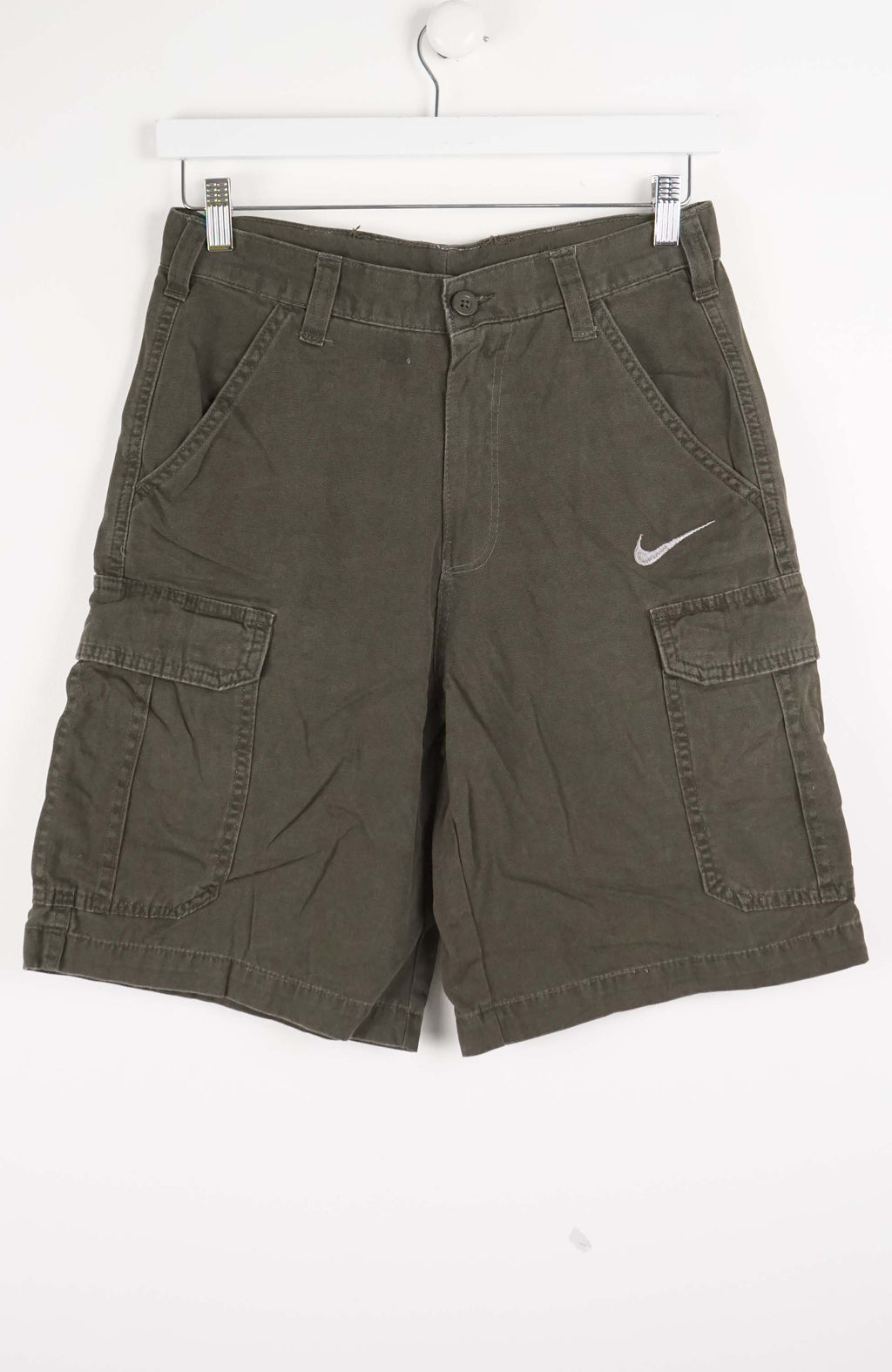 Green cargo shorts with a Nike logo on a white background