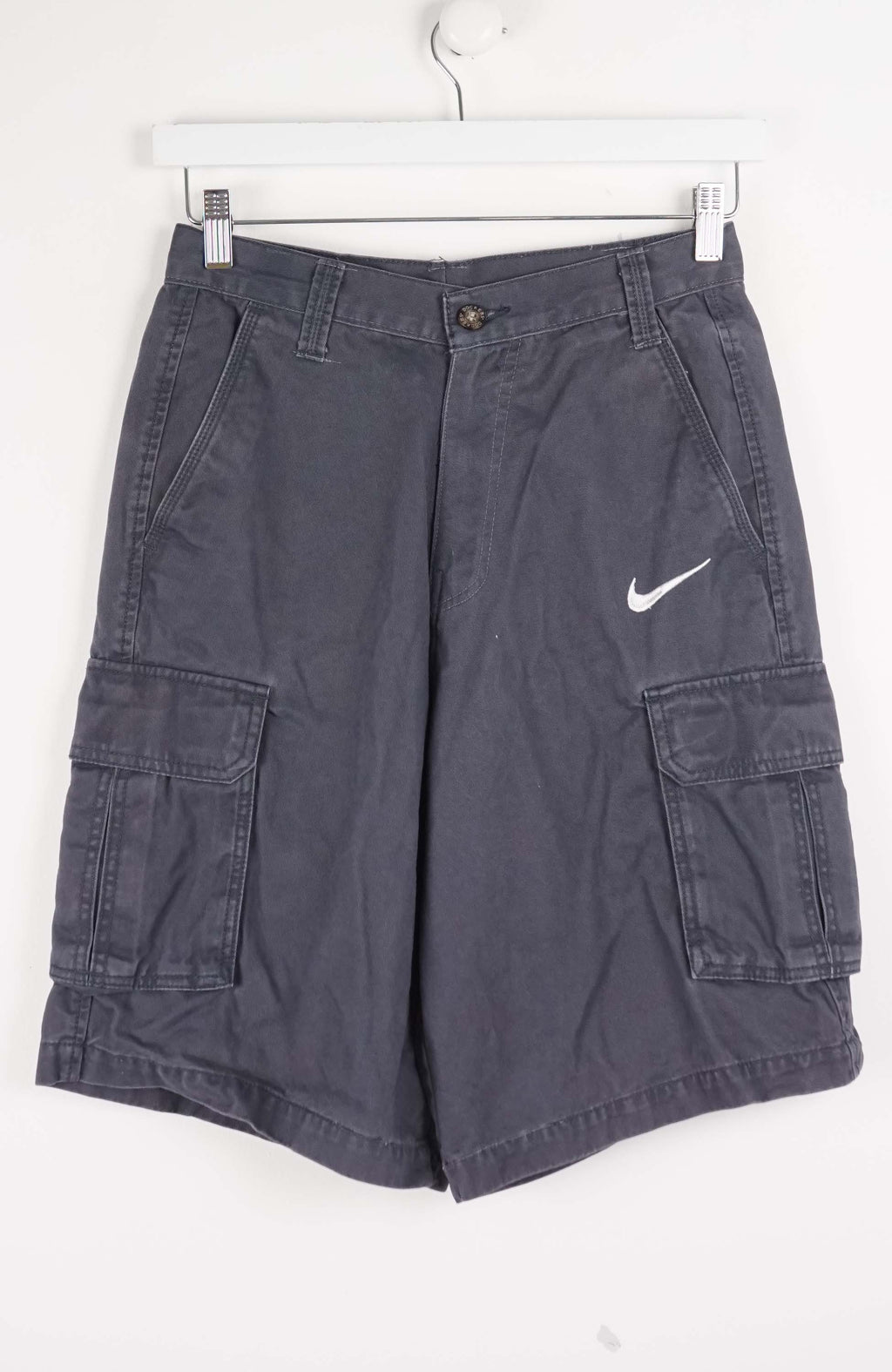 Gray cargo shorts with a Nike logo on a white background