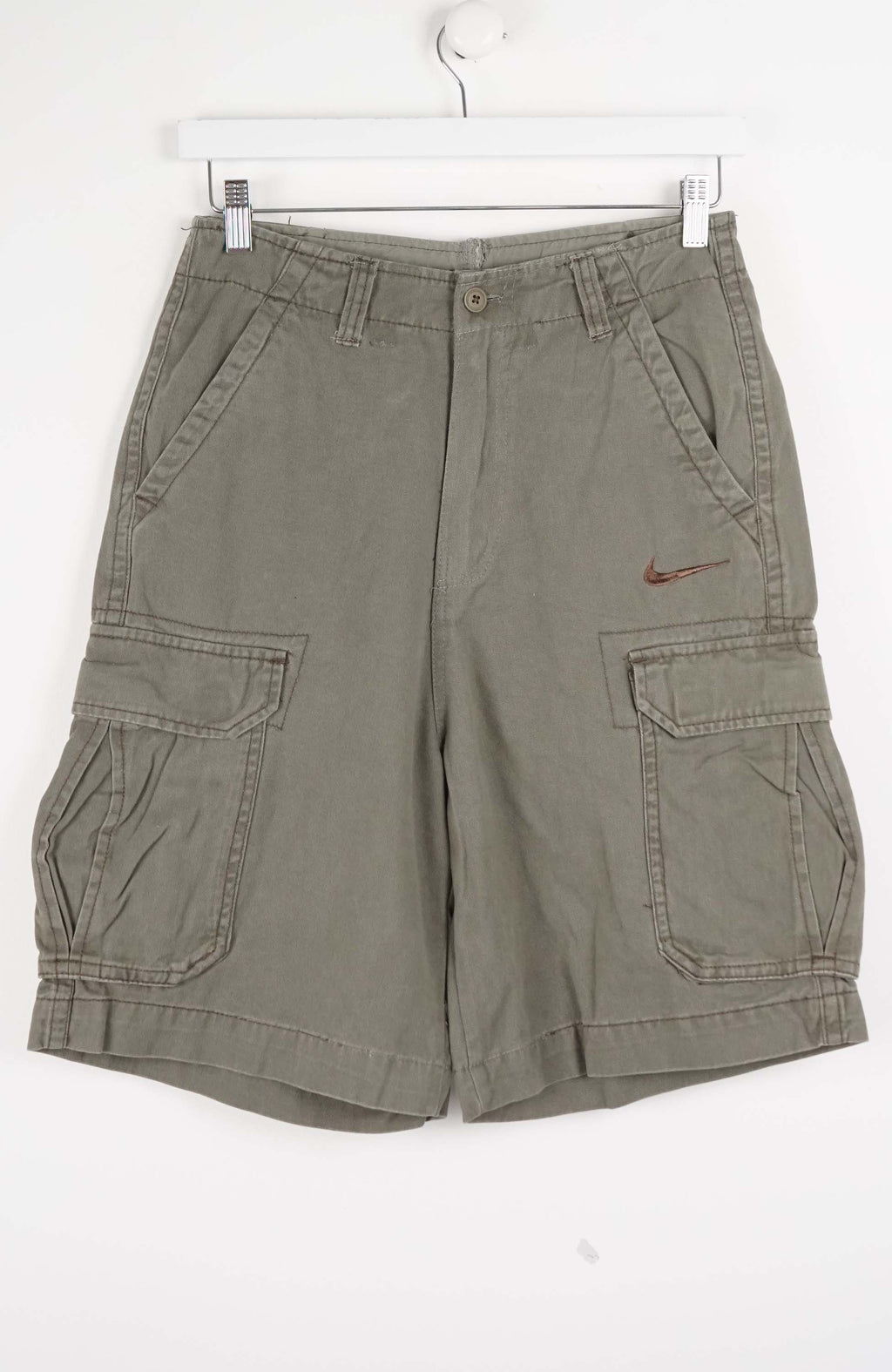 Green cargo shorts with a Nike logo on a white background
