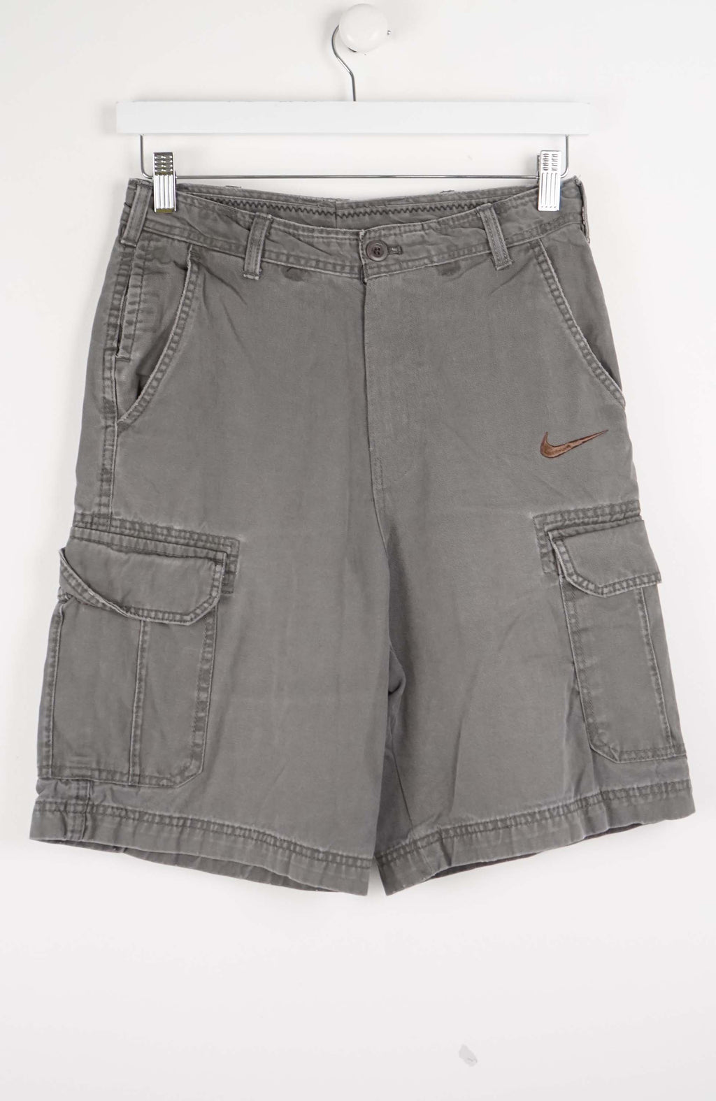 Gray cargo shorts with a Nike logo on a white background