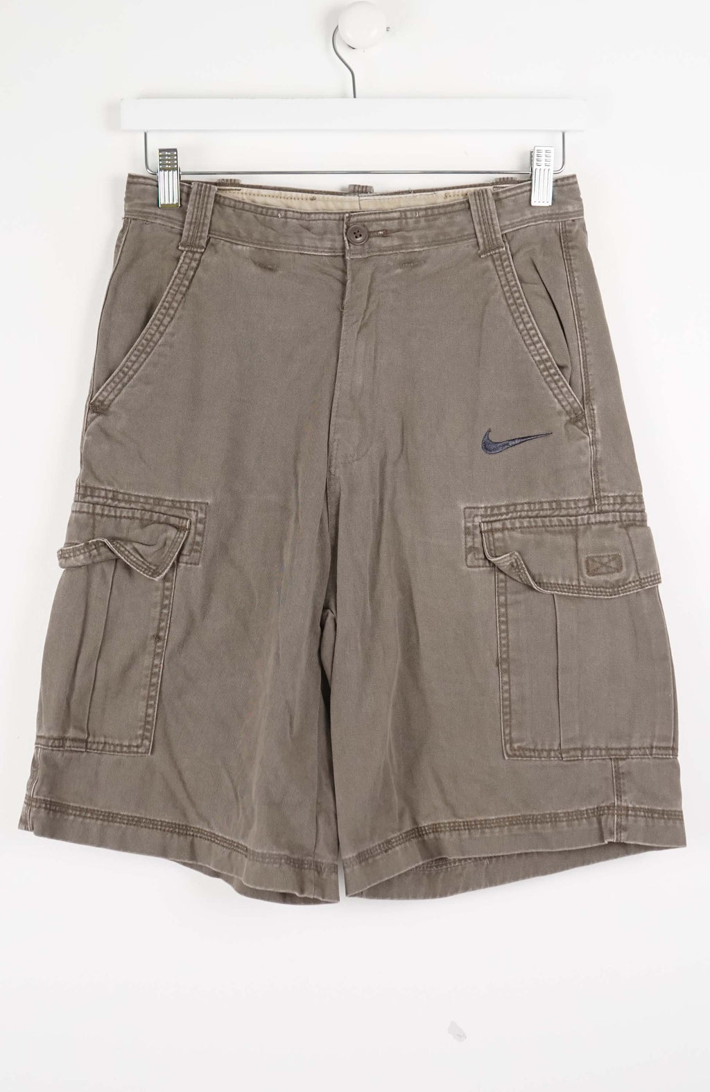 Brown cargo shorts with a Nike logo on a white background