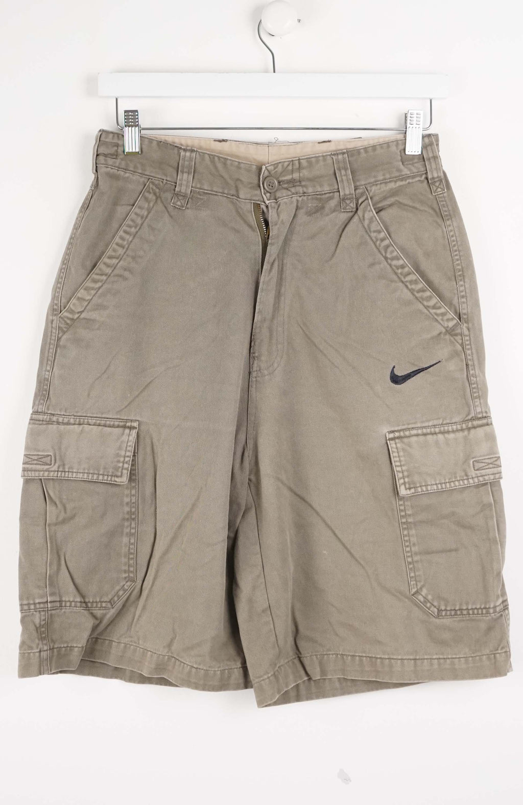 Beige cargo shorts with a Nike logo on a white background