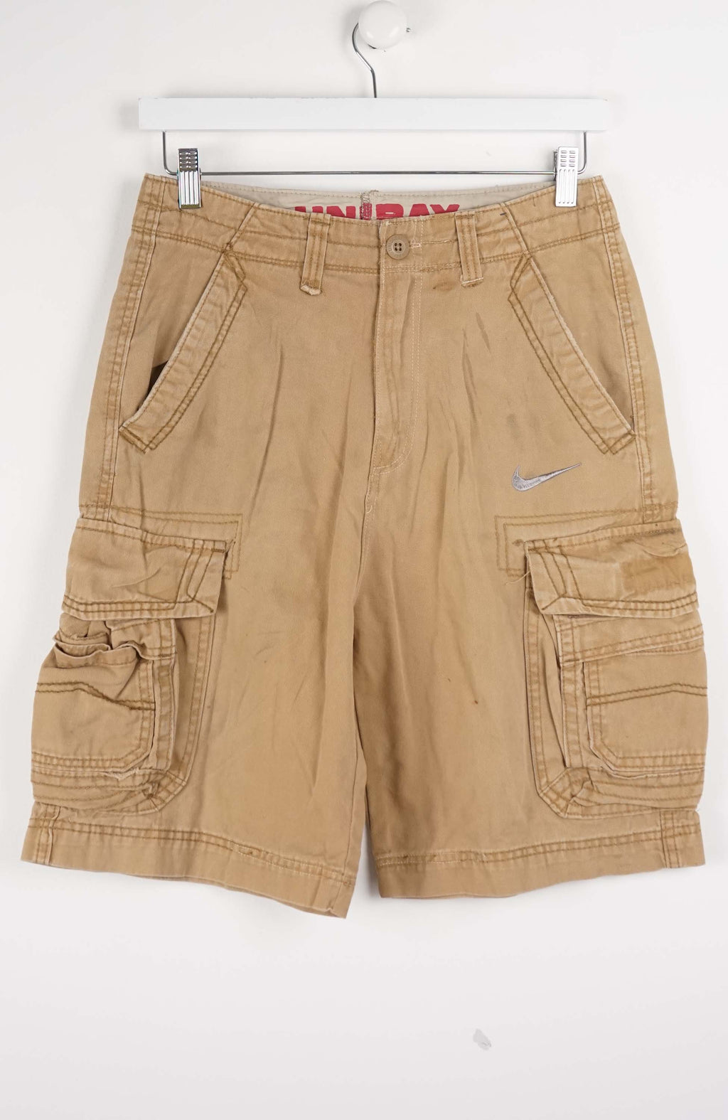 Beige cargo shorts on a white hanger with a white background