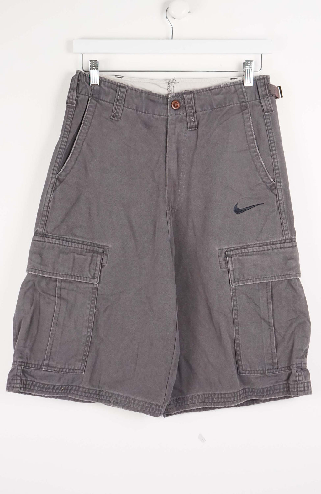 Gray cargo shorts with a Nike logo on a white background