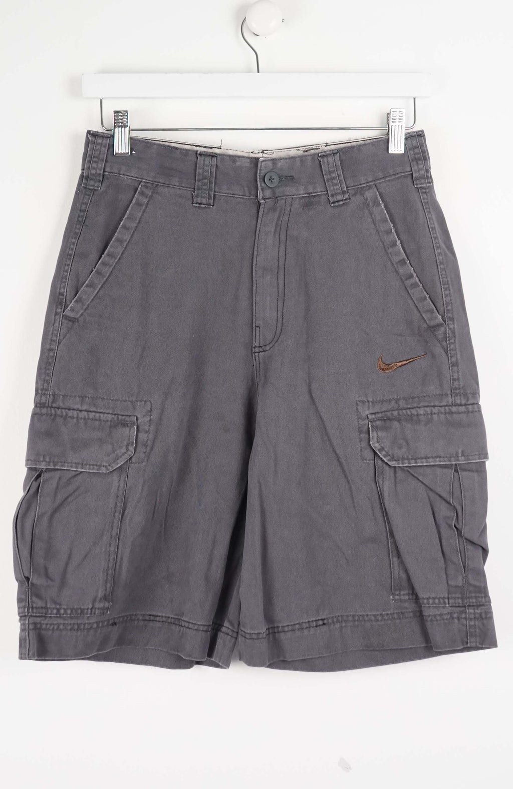Gray cargo shorts with a Nike logo on a white background