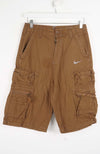Brown cargo shorts with a Nike logo on a white background