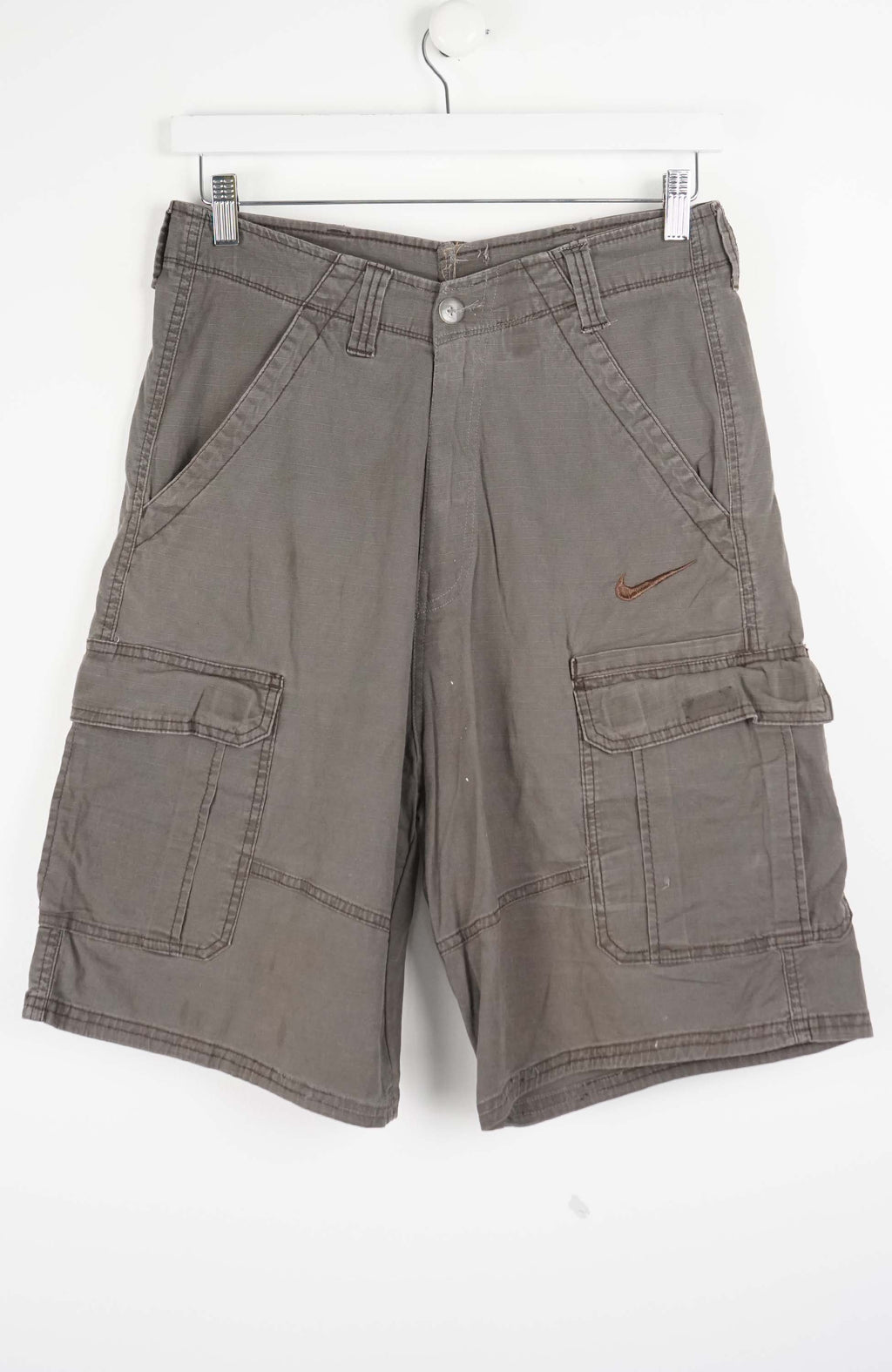 Brown cargo shorts with a Nike logo on a white background