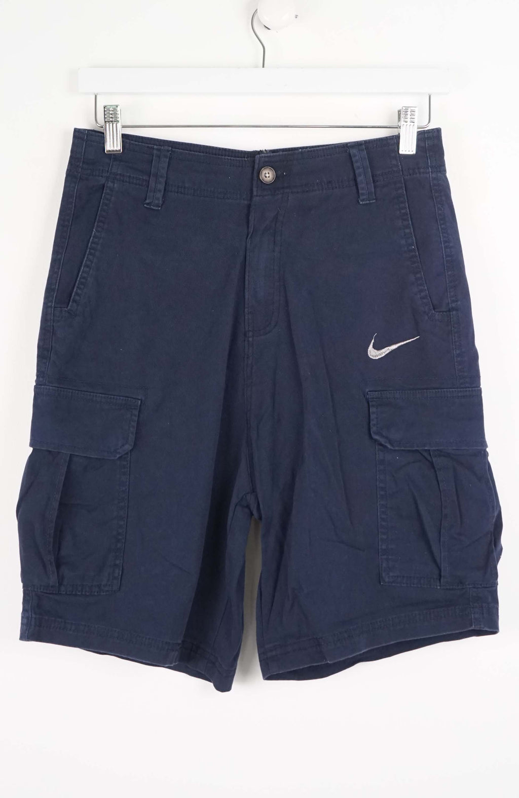 Blue cargo shorts with a Nike logo on a white background