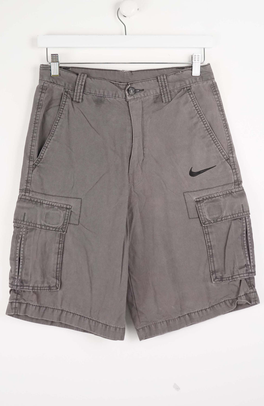 Gray cargo shorts with a Nike logo on a white background