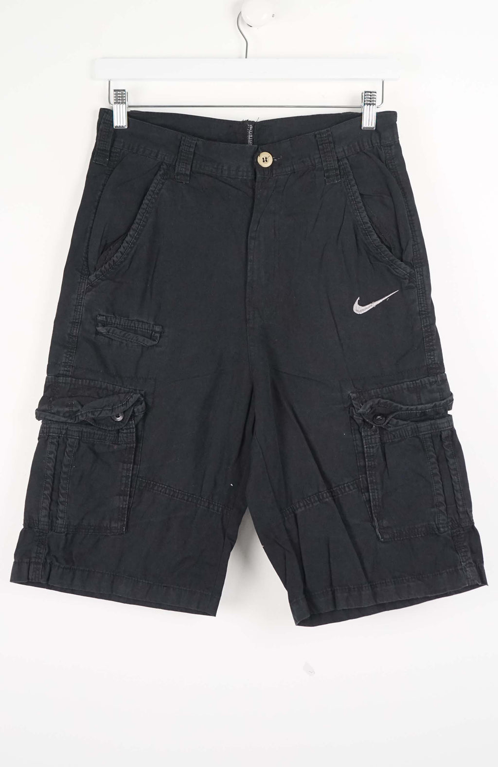 Black cargo shorts with a Nike logo on a white background